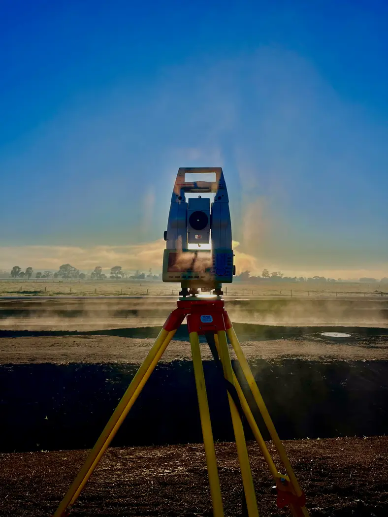 Total station in morning mist on a large site